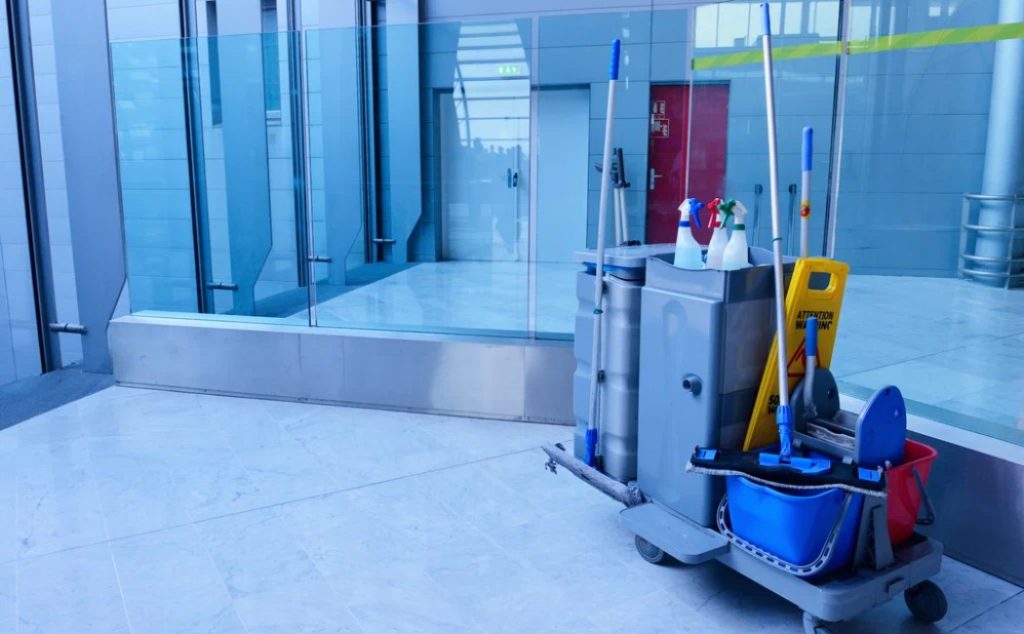 A cleaning cart equipped with eco-friendly supplies is ready for use in a modern space, emphasizing sustainable commercial cleaning services.