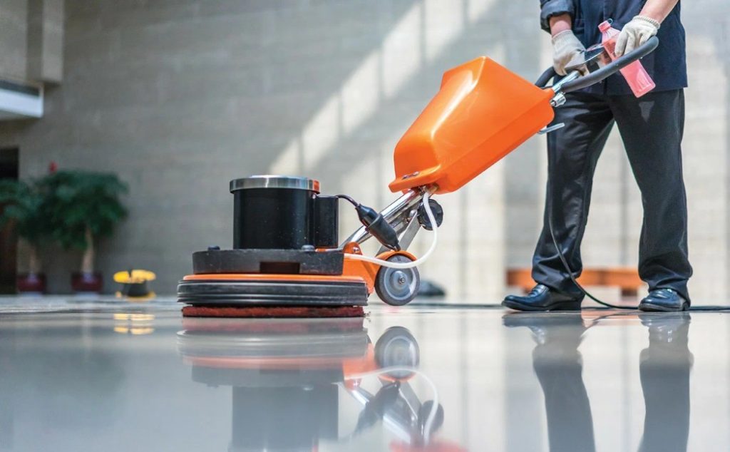A professional uses advanced equipment to polish the floor, showcasing the latest commercial cleaning innovations for efficient and high-quality results.