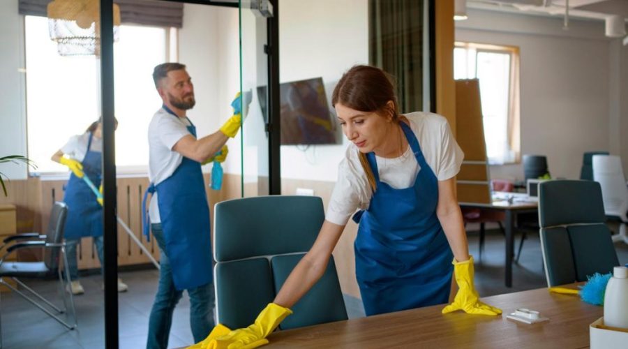 A professional cleaning team is performing commercial cleaning services in a modern office space, ensuring a clean and organized work environment.